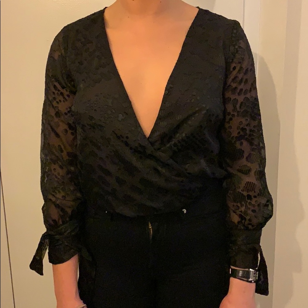 patterned see thru body suit with ties at wrists.